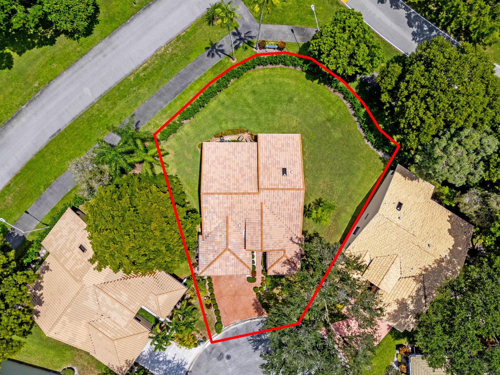 An aerial view shows a house with a tiled roof surrounded by a large yard — 4520 Catamaran Circle, Boynton Beach FL 33436, BOYNTON BEACH, FL