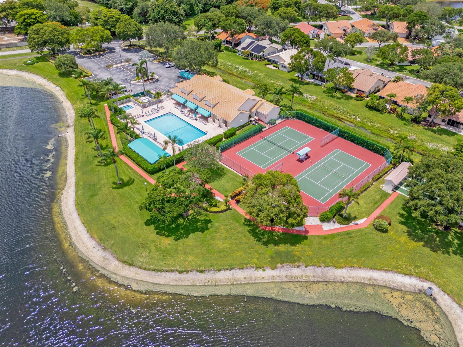 An aerial view shows a community clubhouse with a swimming pool and two tennis courts — 4520 Catamaran Circle, Boynton Beach FL 33436, BOYNTON BEACH, FL