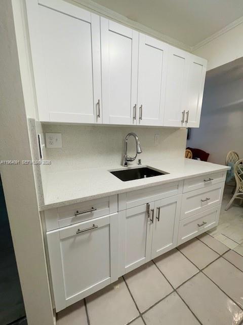 A kitchen features white shaker cabinets, a dark sink, and light-colored countertops — 5180 E Sabal Palm Blvd # 235, Tamarac FL 33319, TAMARAC, FL