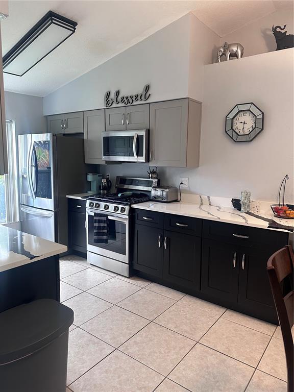 A kitchen features two-toned cabinetry, stainless steel appliances, and white countertops with gray veining — 2527 10TH AVENUE S, ST PETERSBURG, FL