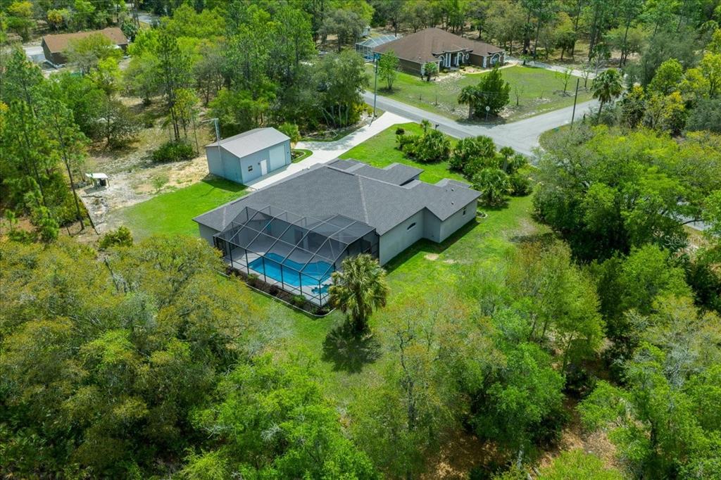 An aerial view shows a house with a screened-in pool and a detached garage — 11667 W BLUEBELL DRIVE, CRYSTAL RIVER, FL