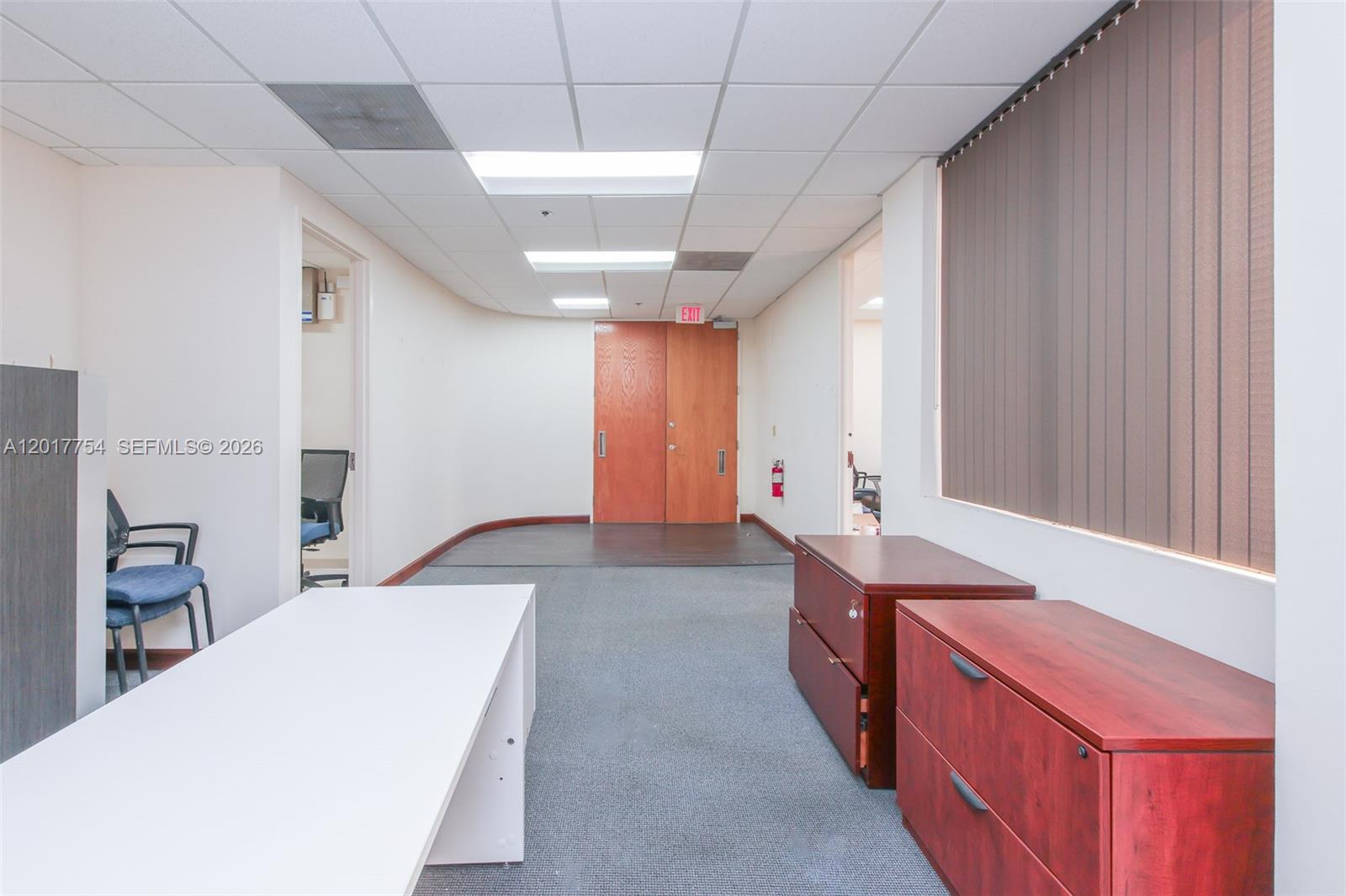 An office space features a white desk, two wooden filing cabinets, and double wooden doors — 1900 Glades Rd # 245, Boca Raton FL 33431, BOCA RATON, FL