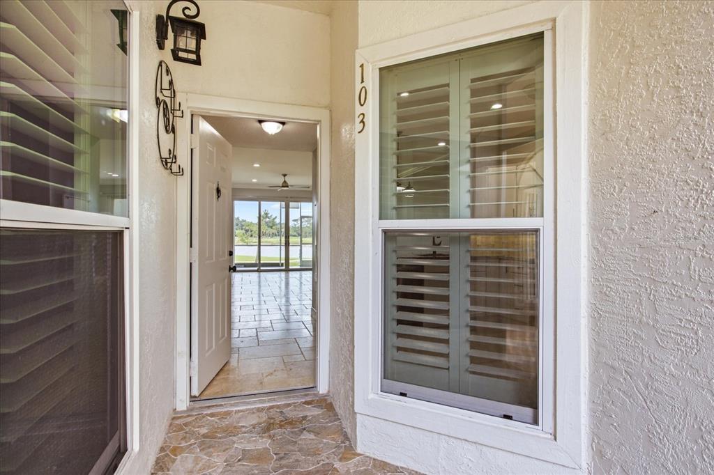 A kitchen features white cabinets, stainless steel appliances, granite countertops, and a subway tile backsplash — 459 HAMPTONCREST CIRCLE UNIT 103, LAKE MARY, FL