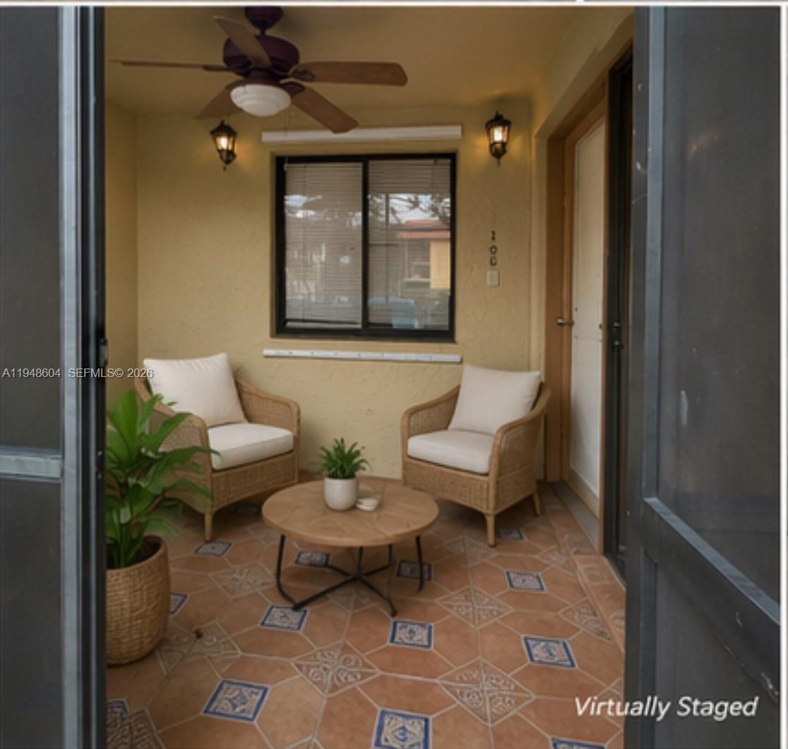 A covered patio features tiled floors, two wicker chairs, a round table, and a ceiling fan — 321 Lakeview Dr # 105, Weston FL 33326, WESTON, FL