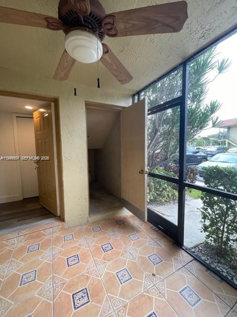 A tiled patio features a ceiling fan, a storage closet, and a screened-in exterior view — 321 Lakeview Dr # 105, Weston FL 33326, WESTON, FL