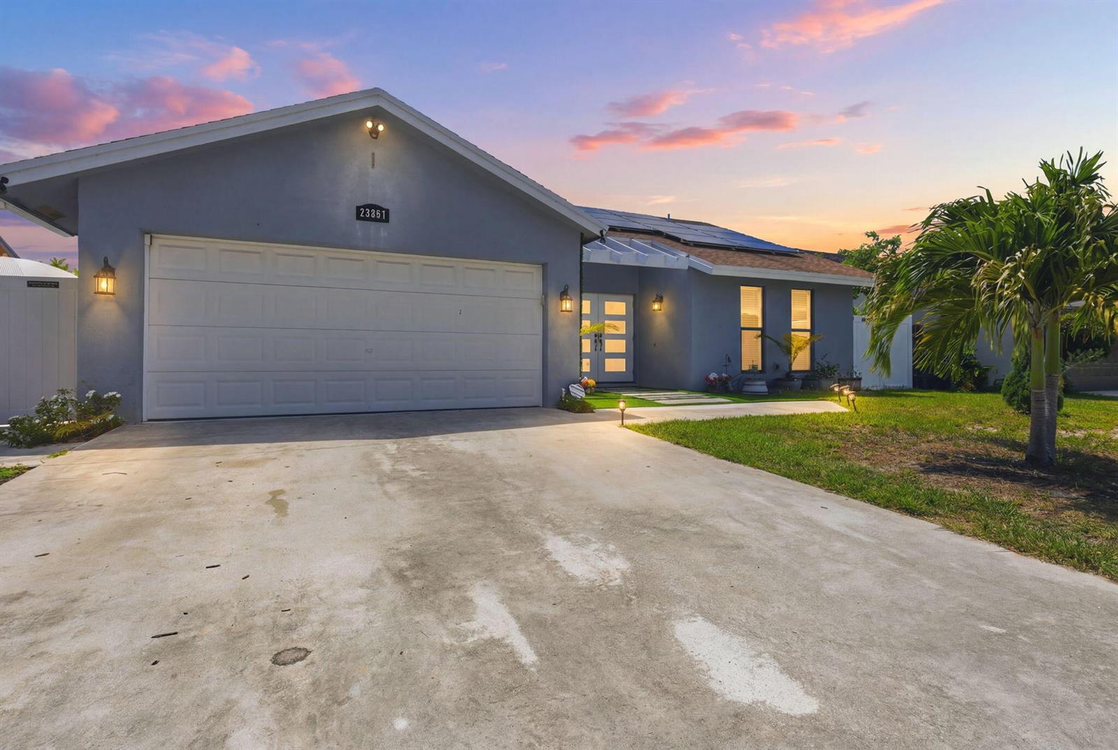 A single-story house with a gray exterior, a two-car garage, and a concrete driveway — 23287 SW 60th Avenue, Boca Raton FL 33428, BOCA RATON, FL