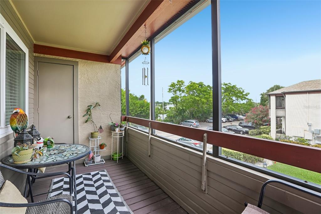 A living room features a fireplace, a sectional sofa, and an adjacent dining area — 10263 GANDY BOULEVARD N UNIT 2416, ST PETERSBURG, FL