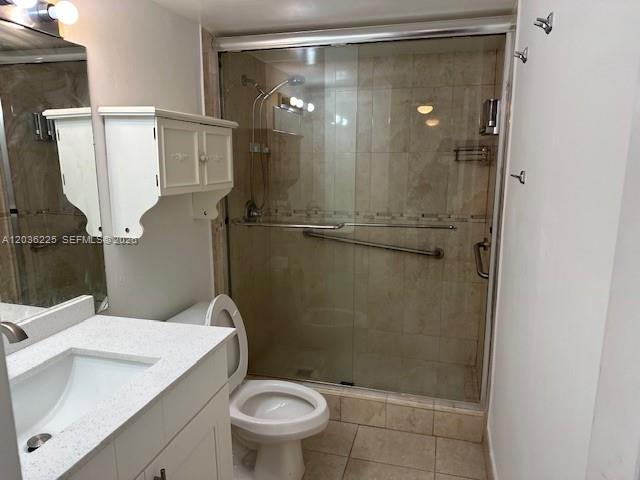 A bathroom features a white vanity, a toilet, and a glass-enclosed walk-in shower — 10900 SW 104th St # 118, Miami FL 33176, MIAMI, FL