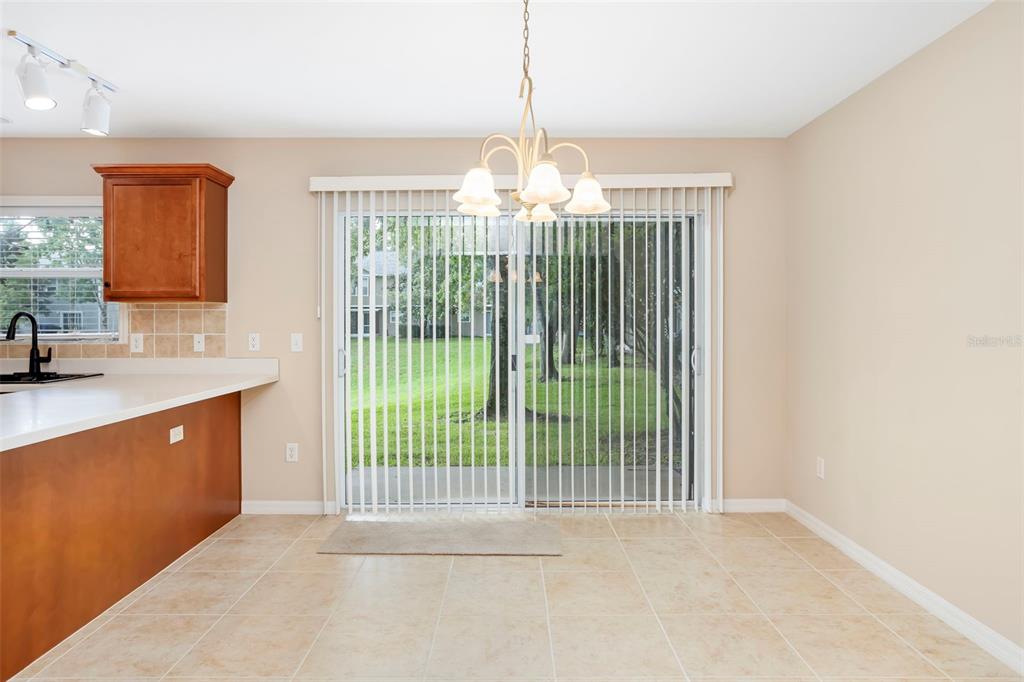 An empty room with beige carpet, light-colored walls, a ceiling fan, and two windows — 2907 BEAR OAK DRIVE, VALRICO, FL