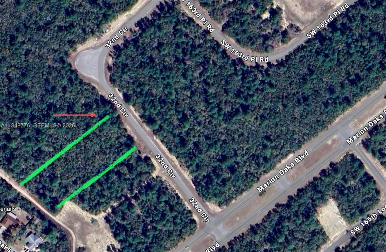 This is an aerial map showing a vacant wooded lot highlighted in green — 32nd Cir / Marion Oaks Blvd, Ocala FL 34473, OCALA, FL