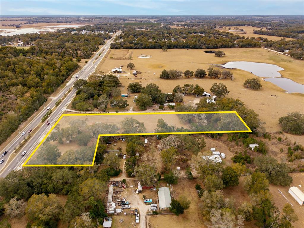 An aerial view shows a rural property with a highlighted parcel of land near a road — 36845 CLINTON AVENUE, DADE CITY, FL