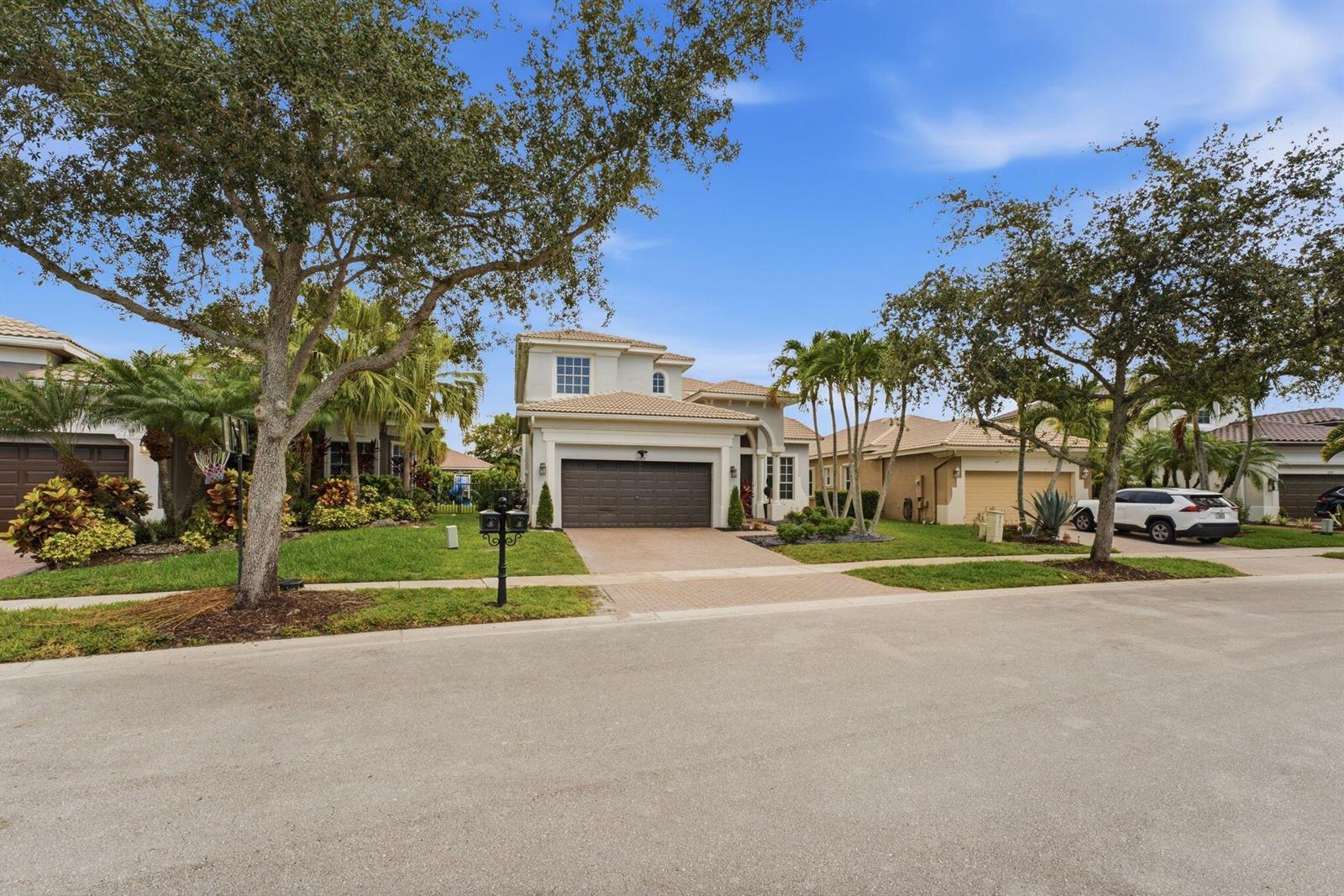 A two-story suburban house with a paved driveway and a two-car garage — 12339 NW 77th Manor, Parkland FL 33076, PARKLAND, FL
