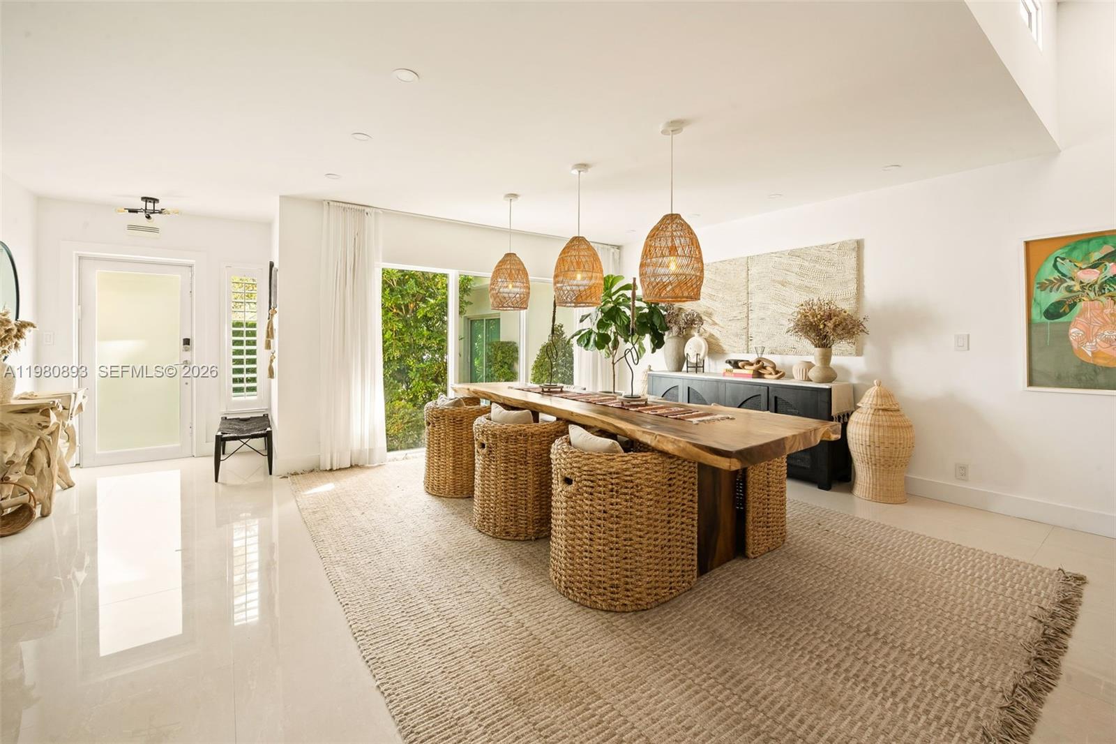A dining room features a live-edge wooden table, woven chairs, and three pendant lights — 865 W 47th St, Miami Beach FL 33140, MIAMI BEACH, FL