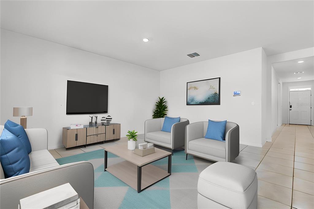 A living room features a television, a coffee table, two armchairs, and a sofa — 11308 AMBER RIDGE DRIVE, ZELLWOOD, FL