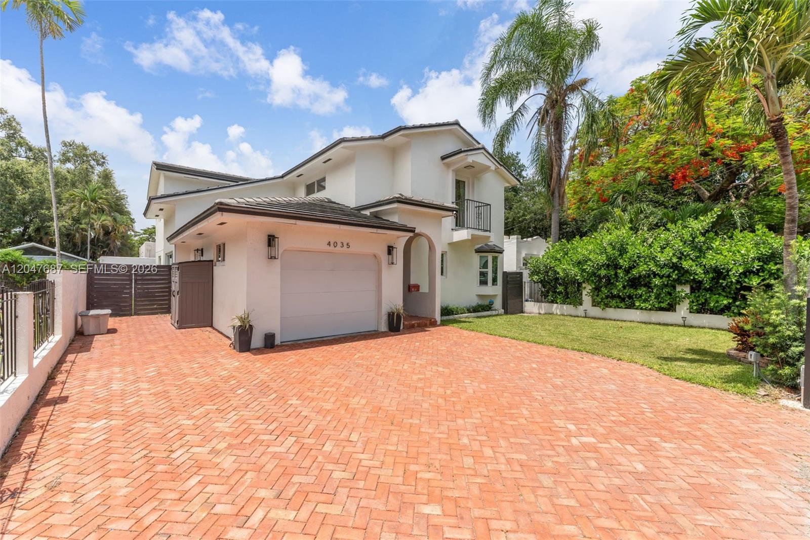 A two-story house features a brick driveway, a single-car garage, and a small balcony — 4035 SW 14th St, Miami FL 33134, MIAMI, FL