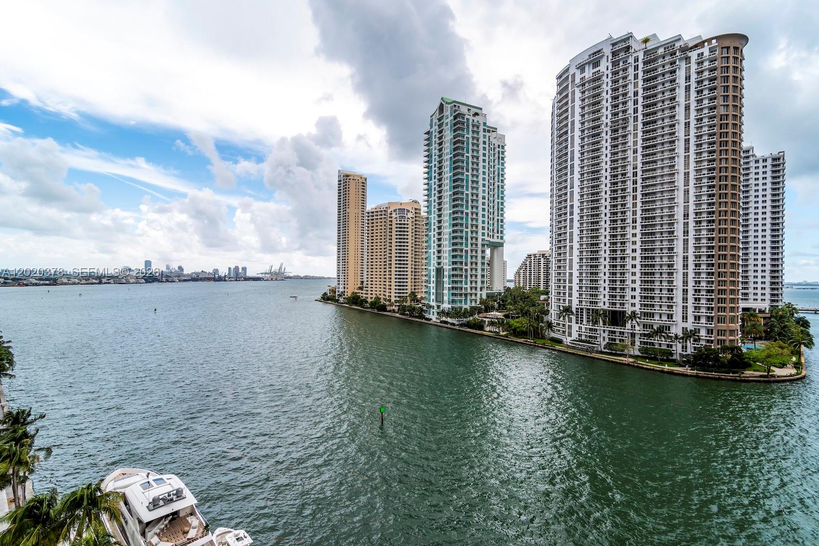 An elevated view of a waterfront bay with several high-rise residential buildings and a yacht — 300 Biscayne Boulevard Way # 802E, Miami FL 33131, MIAMI, FL