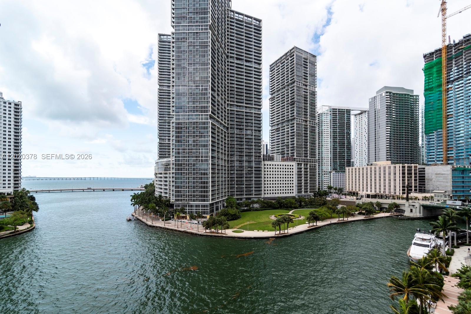 An elevated view shows a waterfront park surrounded by modern high-rise apartment buildings — 300 Biscayne Boulevard Way # 802E, Miami FL 33131, MIAMI, FL