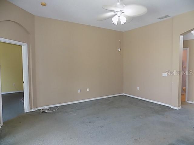 An empty room with beige walls, gray carpeting, and a ceiling fan — 12507 ROCKROSE GLEN, LAKEWOOD RANCH, FL