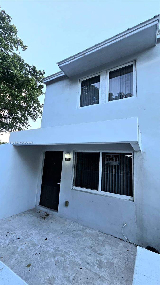 A two-story light blue building exterior features a front door and a for-rent sign — 535 NW 19th St # 369, Miami FL 33136, MIAMI, FL