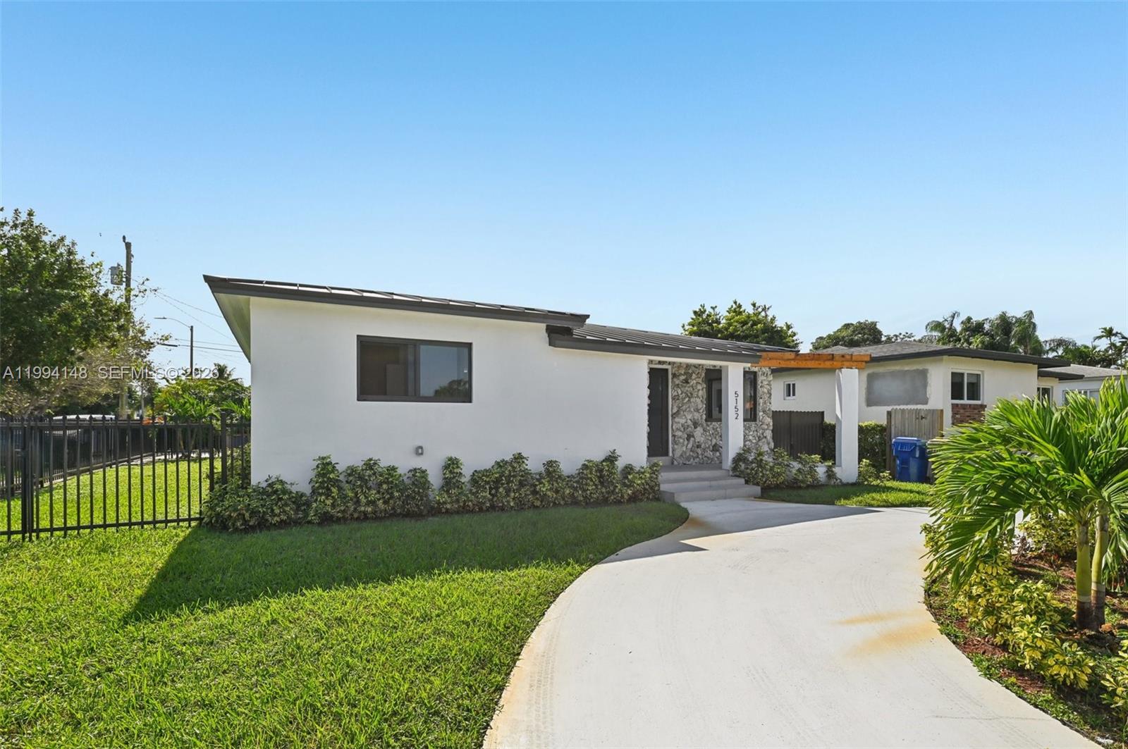 A single-story house with a white exterior, stone accents, and a curved concrete driveway — 5152 SW 6th St, Miami FL 33134, MIAMI, FL