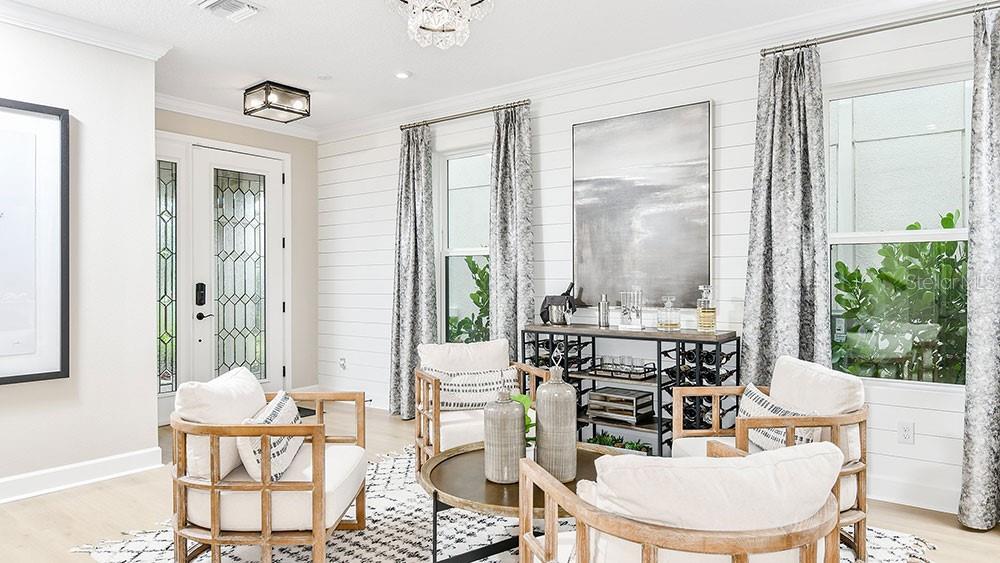 A living room features white shiplap walls, four wooden armchairs, and a metal bar console — 5788 PORTICO PLACE, KISSIMMEE, FL