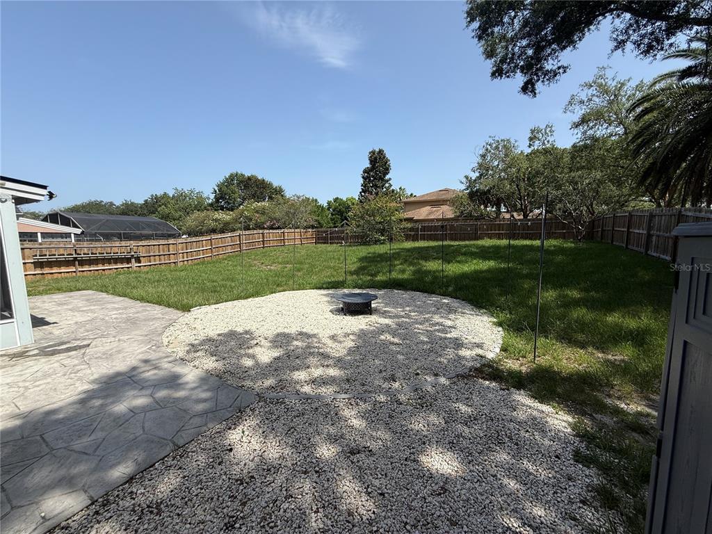 A two-story house with a brick facade, dormer windows, and large oak trees in front — 1927 PALM VIEW DRIVE, APOPKA, FL