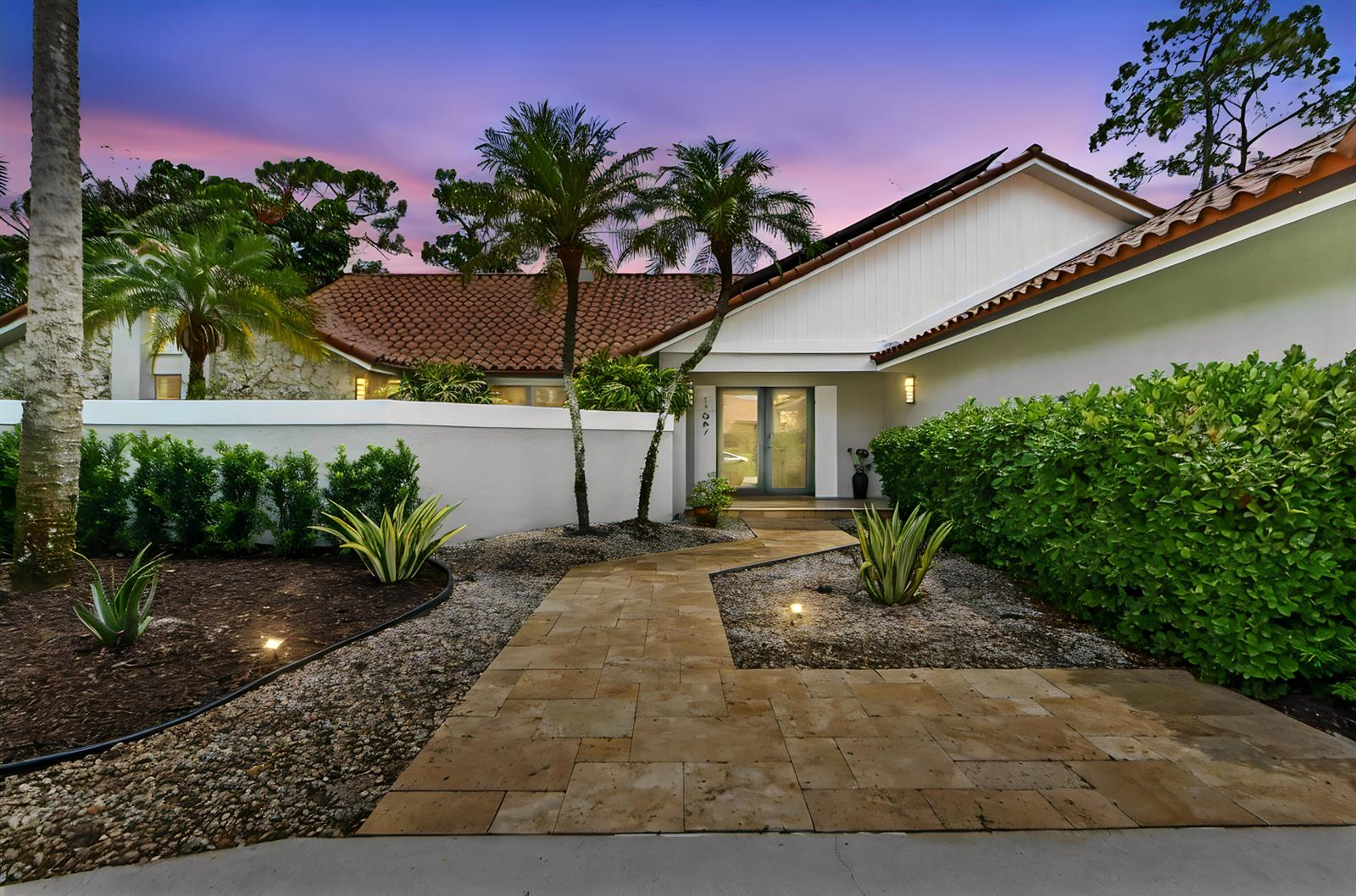A paved walkway leads to the front entrance of a house with a tile roof — 13067 Doubletree Circle, Wellington FL 33414, WELLINGTON, FL