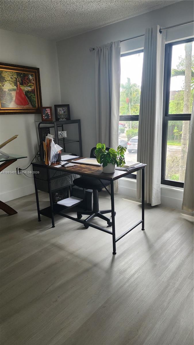 A home office features a desk, a chair, and a large window with curtains — 6231 SW 116th Pl # C, Miami FL 33173, MIAMI, FL