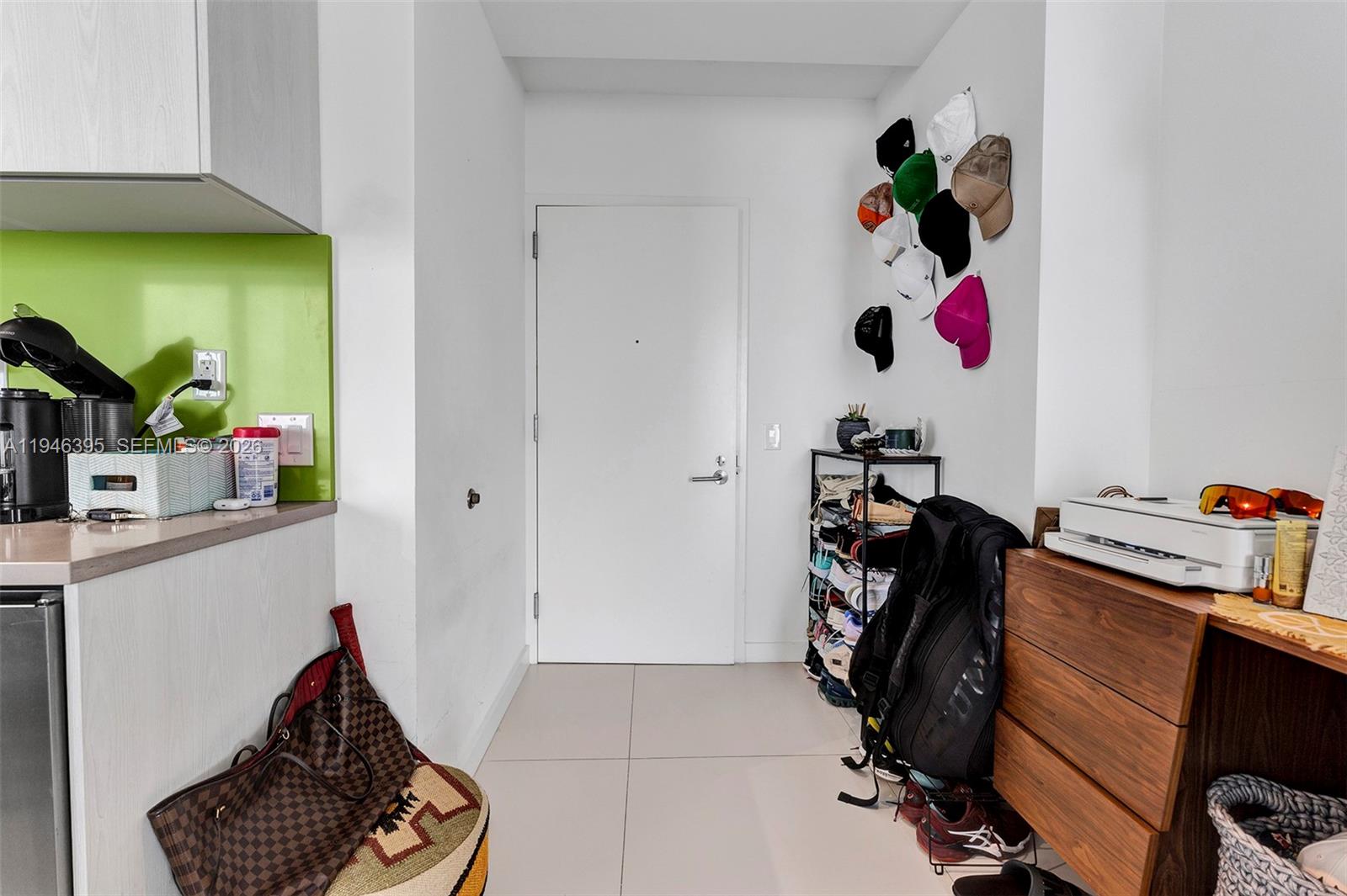 An entryway features a white door, a shoe rack, wall-mounted hats, and a wooden cabinet — 501 NE 31 # 4305, Miami FL 33137, MIAMI, FL