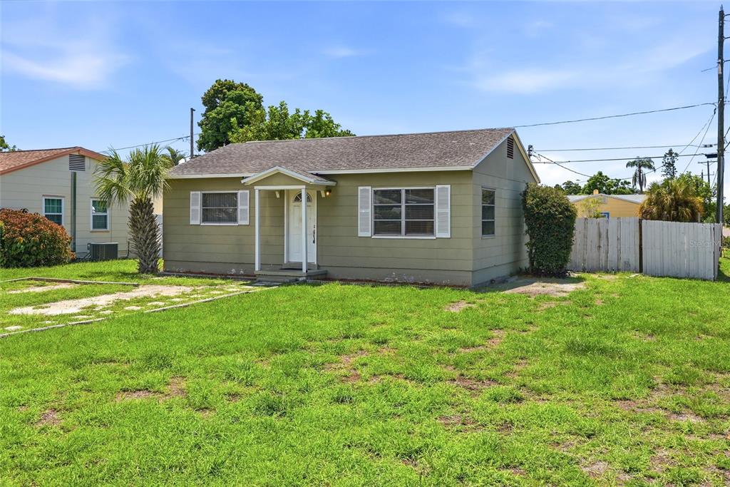 A single-story, light green house with a gabled roof and a small front porch — 701 59TH STREET S, GULFPORT, FL
