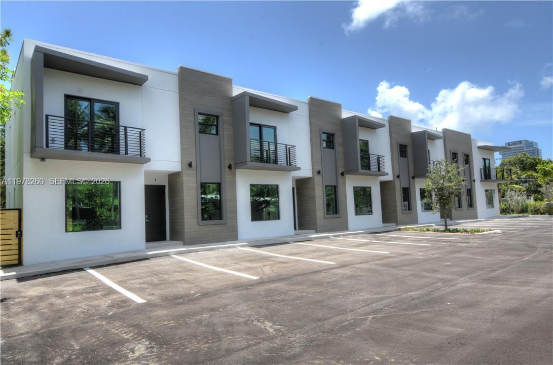 A row of modern two-story townhouses features white and gray facades with private balconies — 211 SE 4th St # 3, Hallandale Beach FL 33009, HALLANDALE BEACH, FL