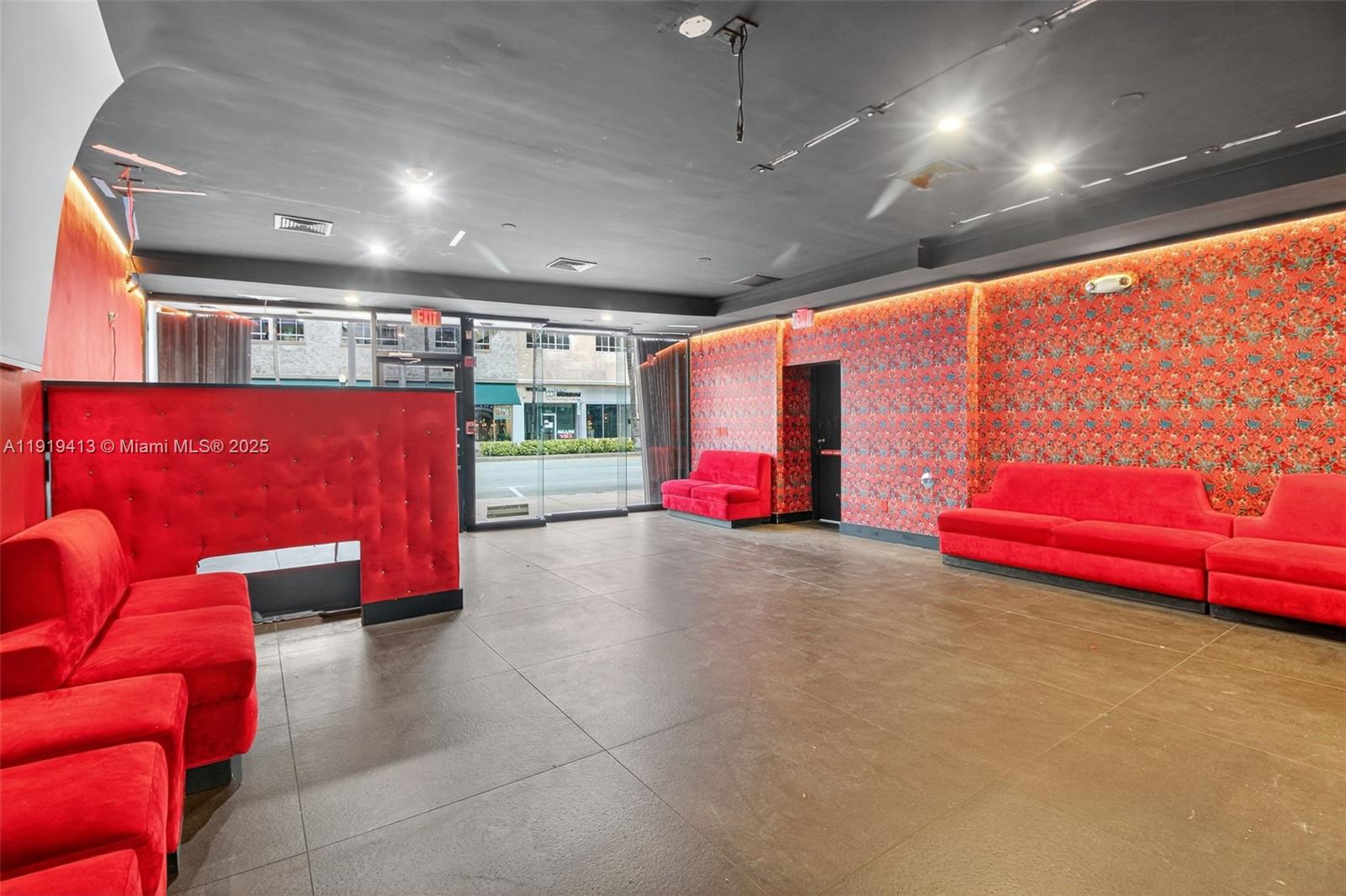 A commercial space features red velvet seating, patterned wallpaper, and a dark grey ceiling — 1218 Washington AVE, Miami Beach FL 33139, MIAMI BEACH, FL