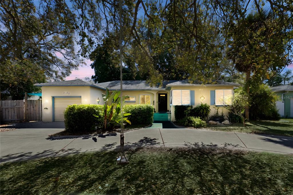 A single-story house with a yellow exterior, a garage, and a curved driveway — 2120 CORONADA WAY S, ST PETERSBURG, FL