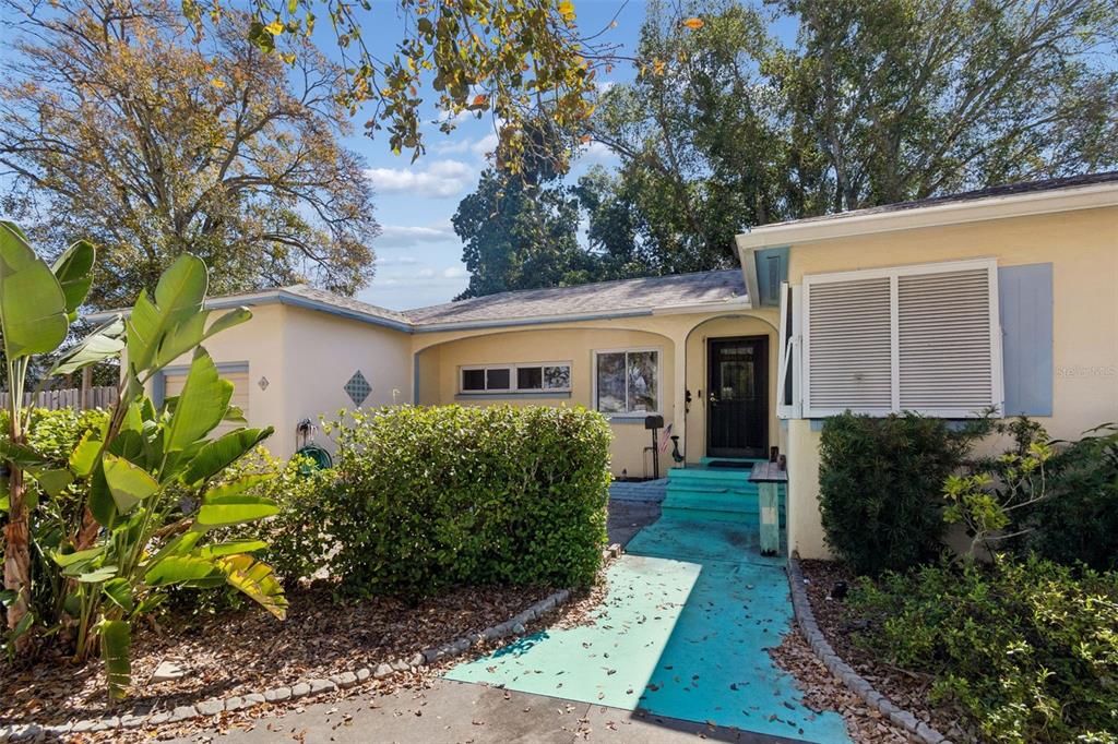 A single-story house with a turquoise walkway leading to a dark front door — 2120 CORONADA WAY S, ST PETERSBURG, FL
