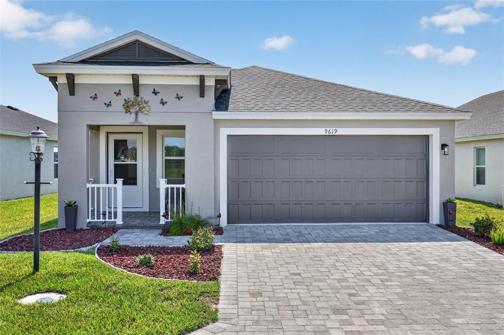 A view from an entryway looking down a hallway toward an open-concept living area — 9619 SW 62ND COURT, OCALA, FL