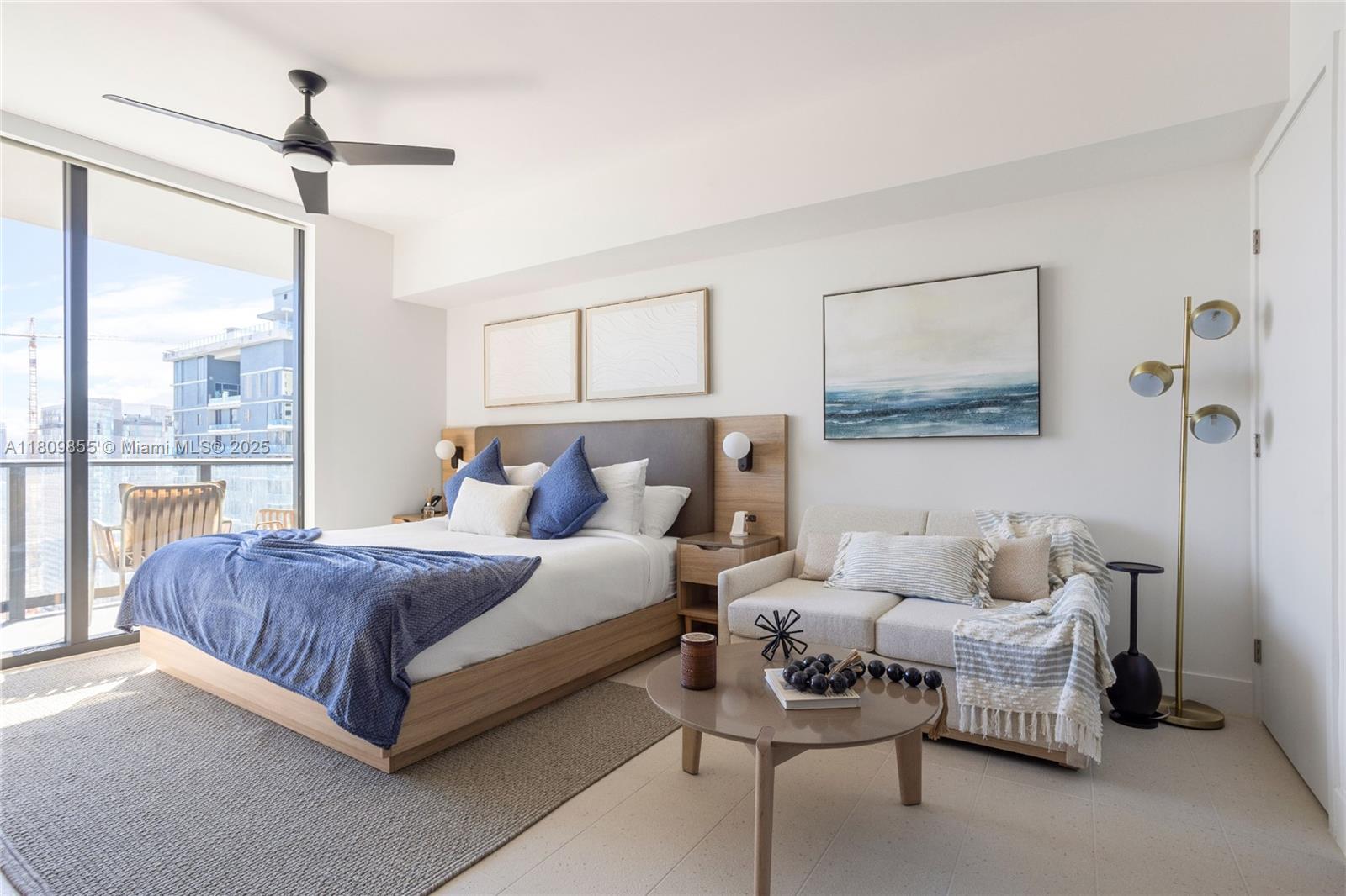 A modern bedroom features a bed, a small sofa, a coffee table, and a balcony — 159 NE 6th St # 3012, Miami FL 33132, MIAMI, FL