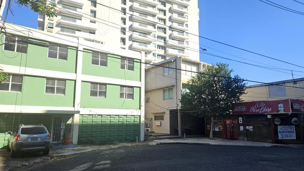 A street-level view shows a green building, a white building, and a small restaurant — 11 VELA ST., SAN JUAN, PR