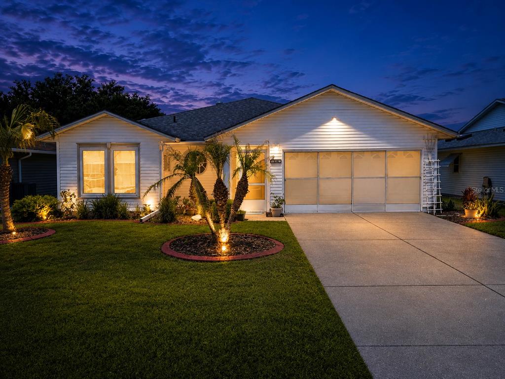 A single-story white house with a garage and a palm tree in the front yard — 3526 INNISBROOK DRIVE, LAKELAND, FL