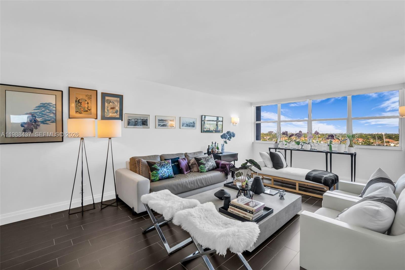 A living room features dark wood floors, a gray sofa, white armchairs, and large windows — 1400 S Ocean Dr # 804, Hollywood FL 33019, HOLLYWOOD, FL