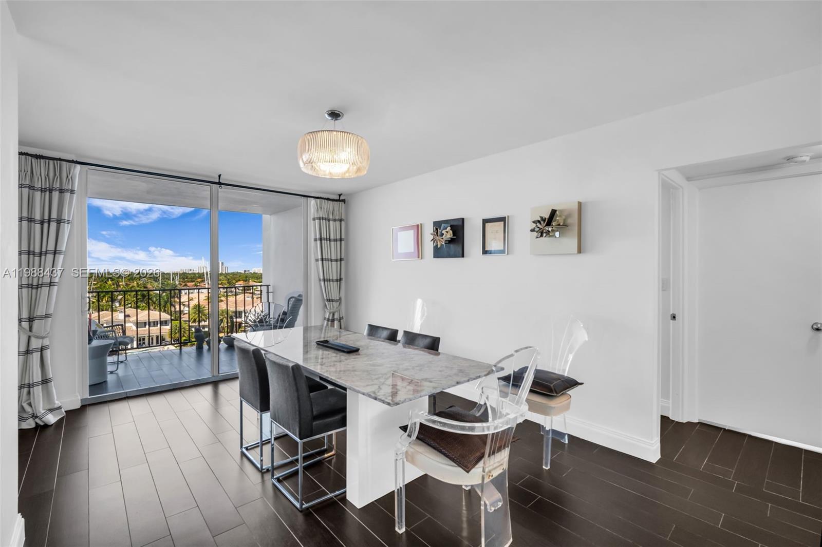 A dining room features a marble table, mixed seating, and a balcony with water views — 1400 S Ocean Dr # 804, Hollywood FL 33019, HOLLYWOOD, FL