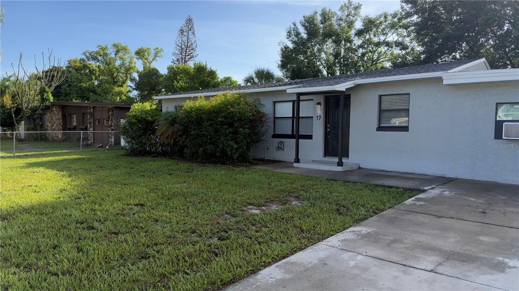 A single-story house with a gray exterior, a concrete driveway, and a front lawn — 17 S SOLANDRA DRIVE, ORLANDO, FL
