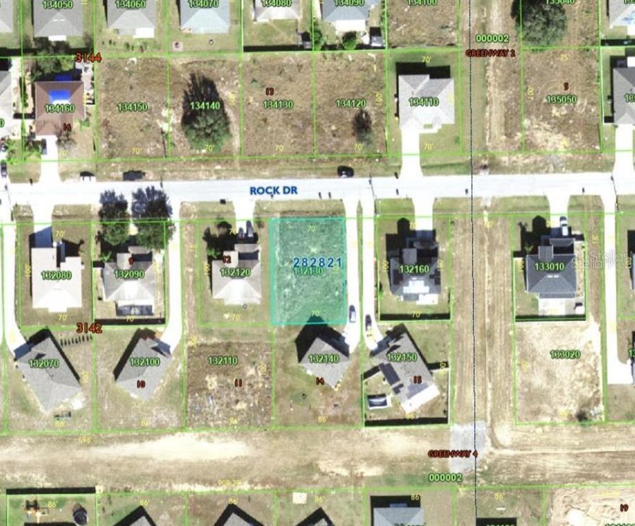 This is a satellite map view showing a vacant residential lot highlighted on a street — 2173 ROCK DRIVE, KISSIMMEE, FL