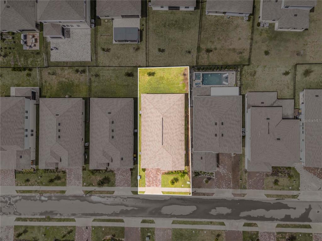 An aerial view shows a single-family home with a fenced backyard on a residential lot — 4716 WALTHAM FOREST DRIVE, DAVENPORT, FL