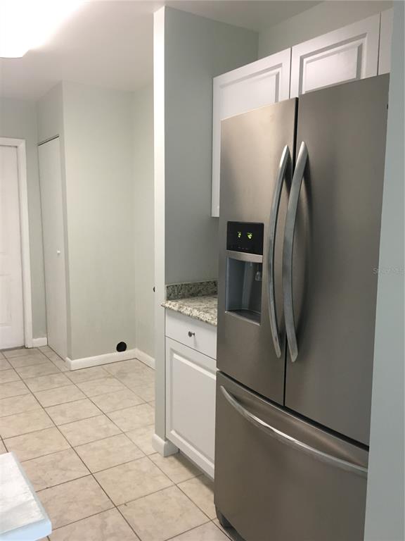 A living room features white tile flooring, two sofas, and a dining area in the background — 605 NORTHLAKE BOULEVARD UNIT 75, ALTAMONTE SPRINGS, FL