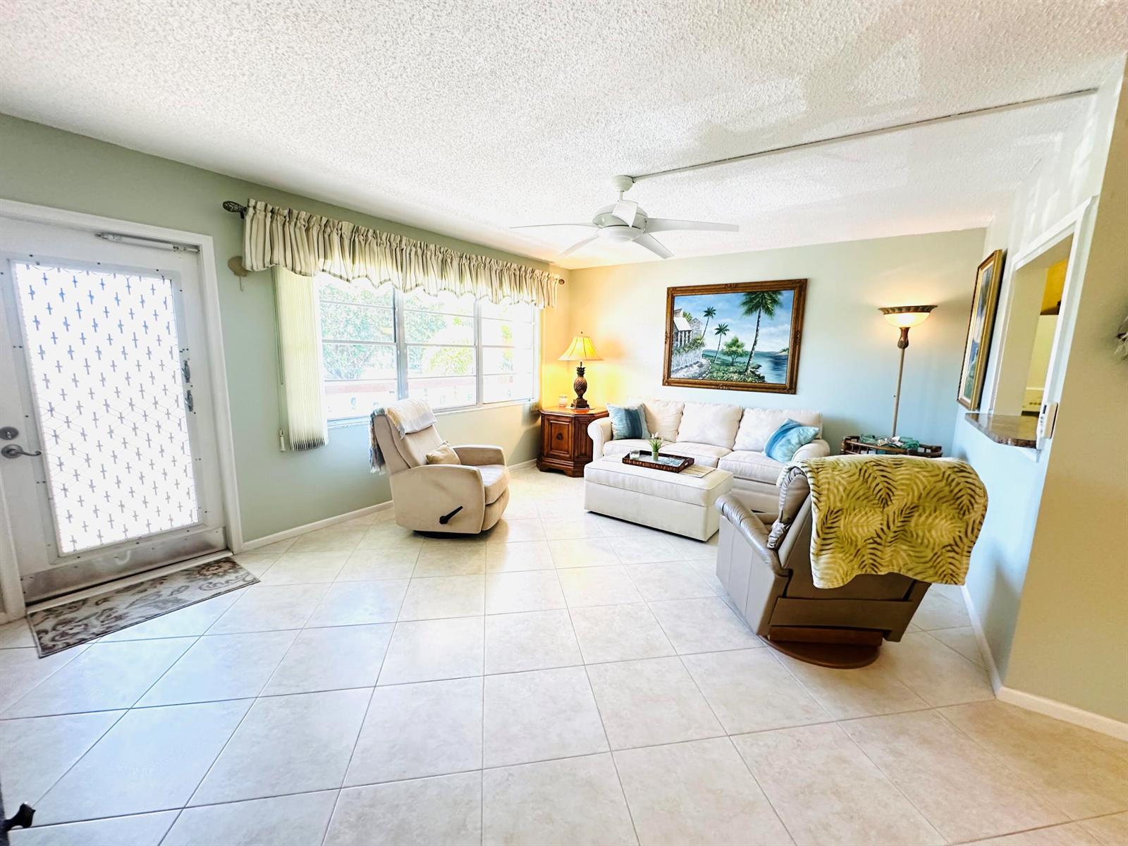 A living room features light tile flooring, a ceiling fan, and a beige sofa set — 2132 Cambridge F # 2132, Deerfield Beach FL 33442, DEERFIELD BEACH, FL