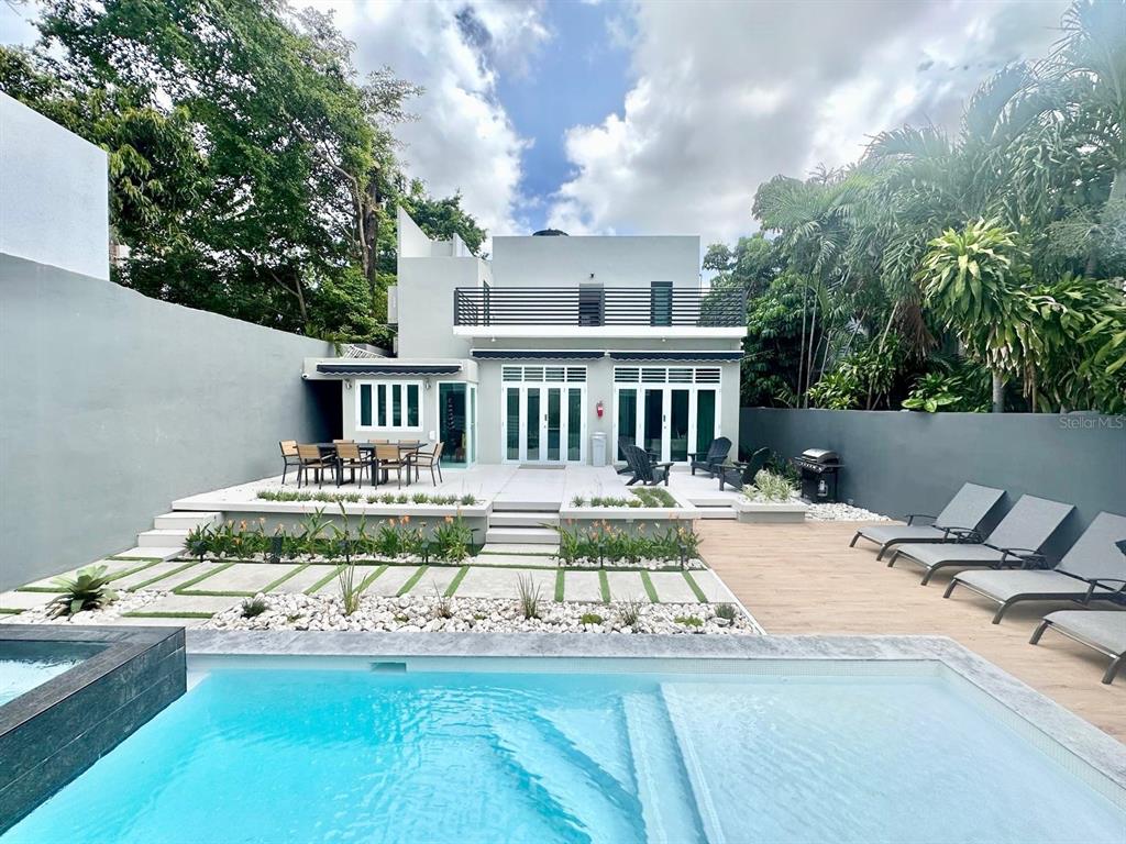 A modern two-story house features a backyard with a swimming pool and patio seating — 1419 CALLE ESTRELLA, SAN JUAN, PR
