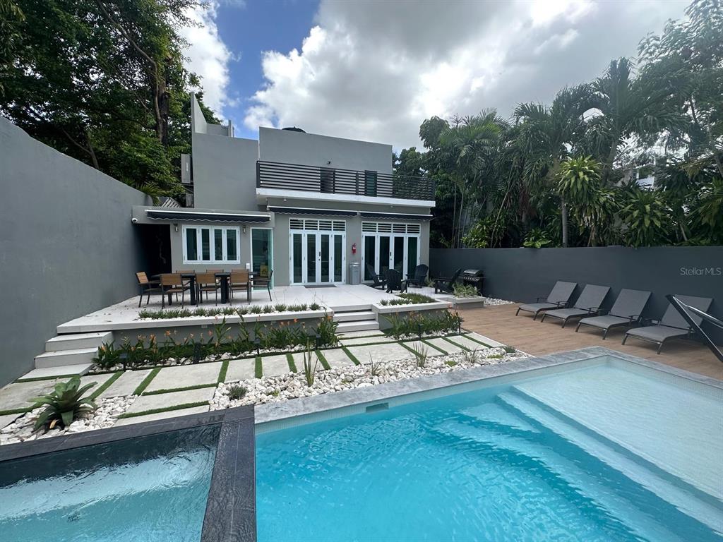 A modern two-story house features a backyard patio, swimming pool, and lounge chairs — 1419 CALLE ESTRELLA, SAN JUAN, PR