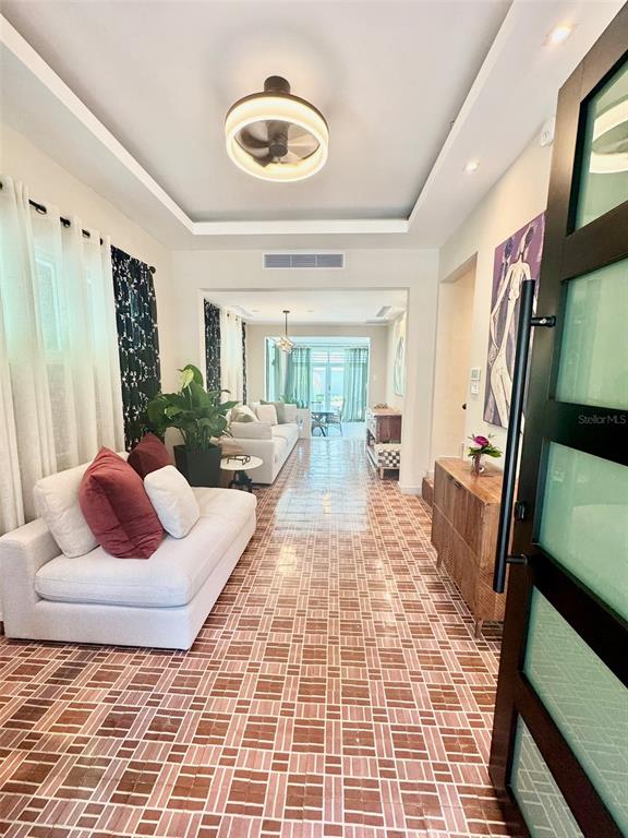 A living room features a white sofa, tiled floors, and a modern ceiling fan light — 1419 CALLE ESTRELLA, SAN JUAN, PR