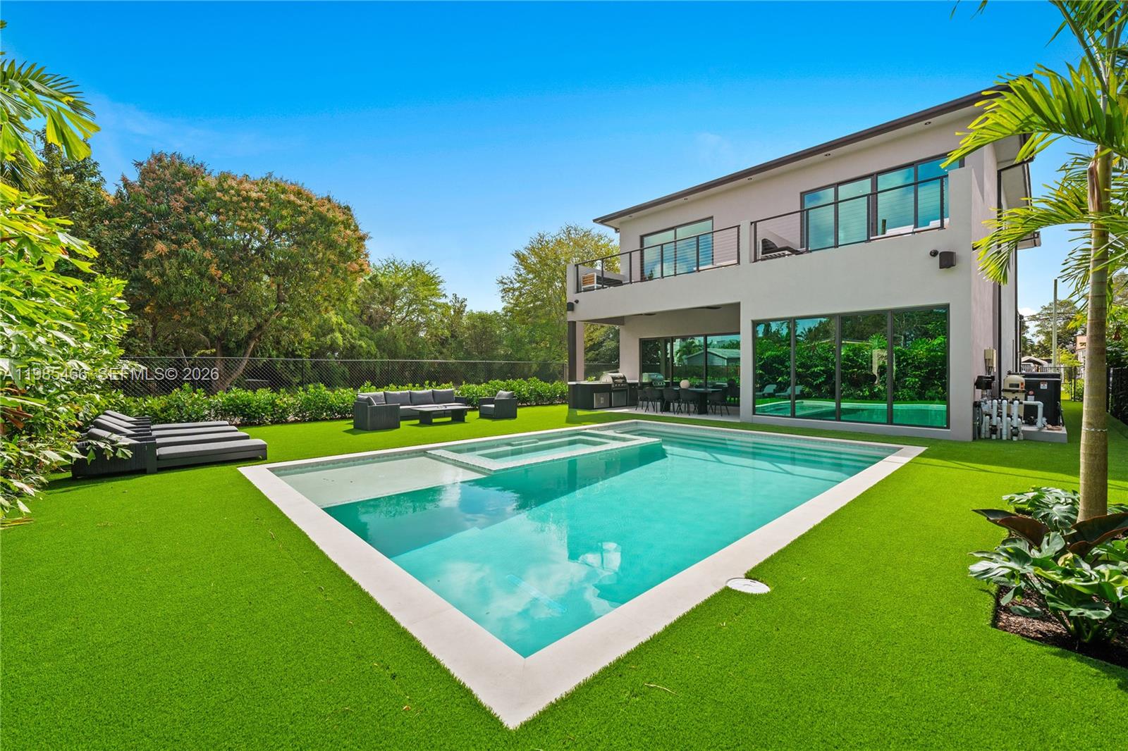 A modern two-story house features a swimming pool and artificial turf in the backyard — 245 NE 116th St, Miami FL 33161, MIAMI, FL