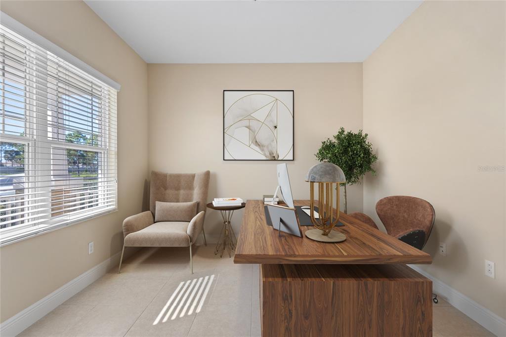 A home office features a wooden desk, a tan armchair, and a framed horse wall art — 3835 AUTUMN FERN TERRACE, SARASOTA, FL